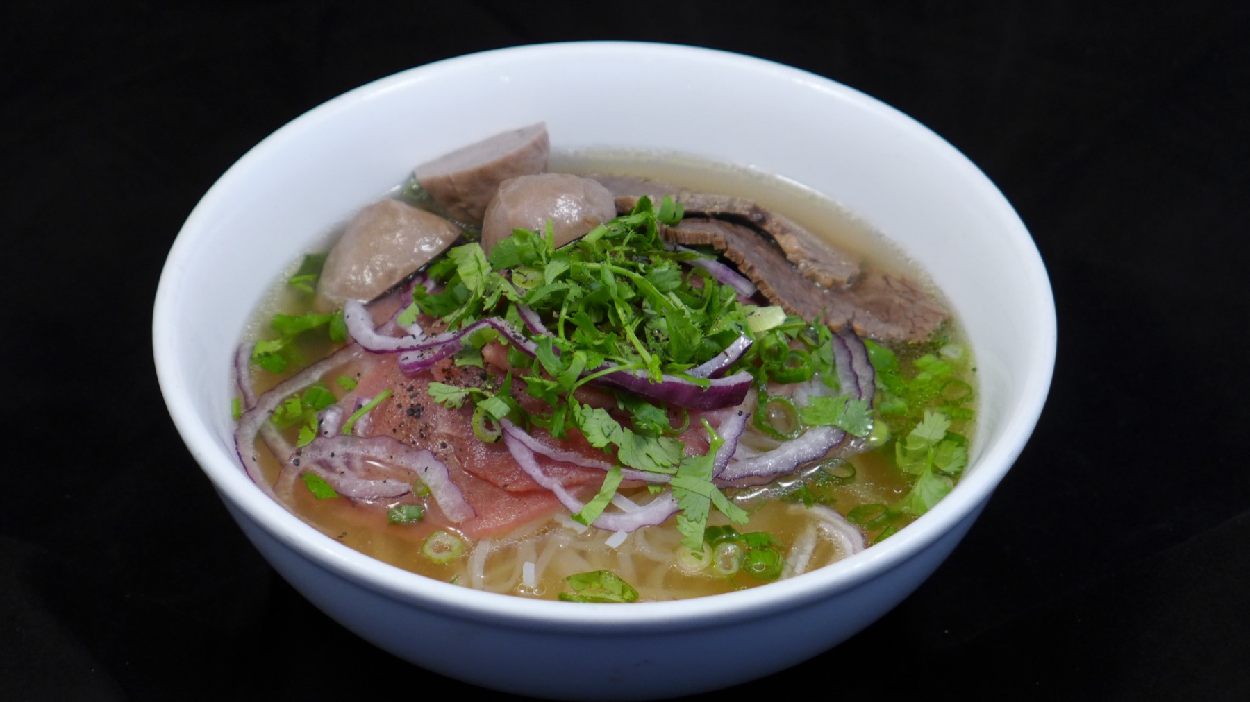 Bowl of Cafe Trang beef pho with fresh herbs